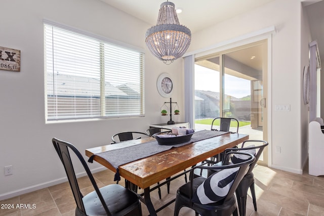 dining area with an inviting chandelier and plenty of natural light