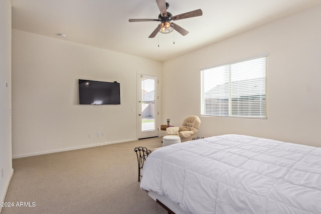 bedroom with access to exterior, light colored carpet, and ceiling fan