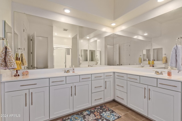 bathroom with tile patterned flooring, vanity, and an enclosed shower