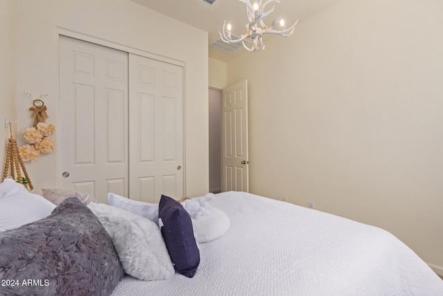 bedroom featuring a chandelier and a closet