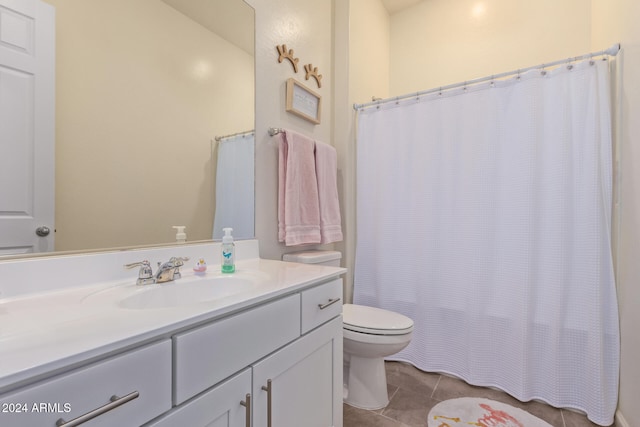 bathroom featuring a shower with curtain, tile patterned flooring, vanity, and toilet