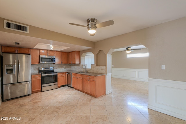 406 E Saguaro St, Casa Grande, AZ 85122 - kitchen featuring light stone counters, stainless steel appliances, sink, and decorative backsplash