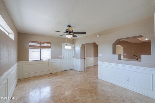 406 E Saguaro St, Casa Grande, AZ 85122 - empty room with light tile patterned floors, a textured ceiling, and ceiling fan