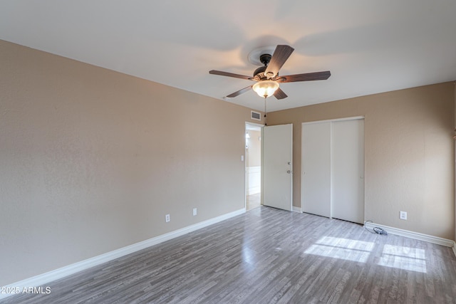 406 E Saguaro St, Casa Grande, AZ 85122 - unfurnished bedroom with hardwood / wood-style flooring, a closet, and ceiling fan