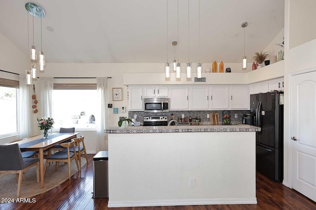 kitchen with a center island with sink, decorative backsplash, hanging light fixtures, stainless steel appliances, and white cabinets