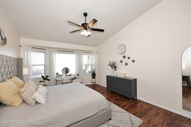 bedroom with ceiling fan, vaulted ceiling, and dark hardwood / wood-style floors