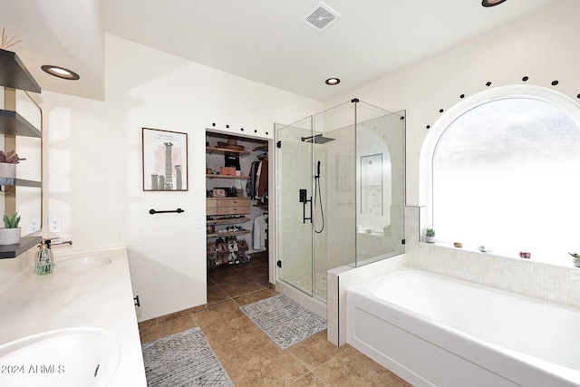 bathroom featuring vanity and shower with separate bathtub