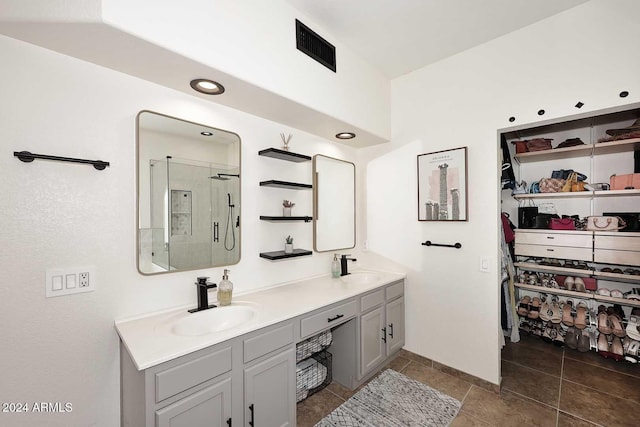 bathroom with vanity, tile patterned flooring, and a shower with door