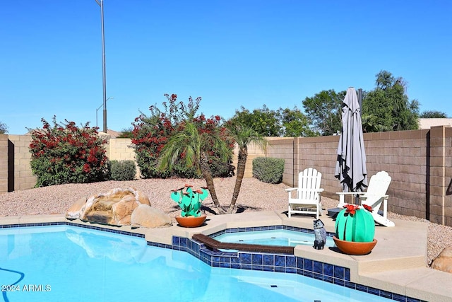 view of swimming pool featuring an in ground hot tub