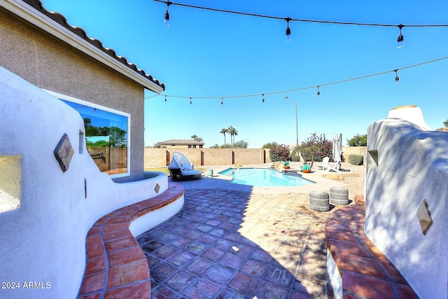 view of patio / terrace with a fenced in pool