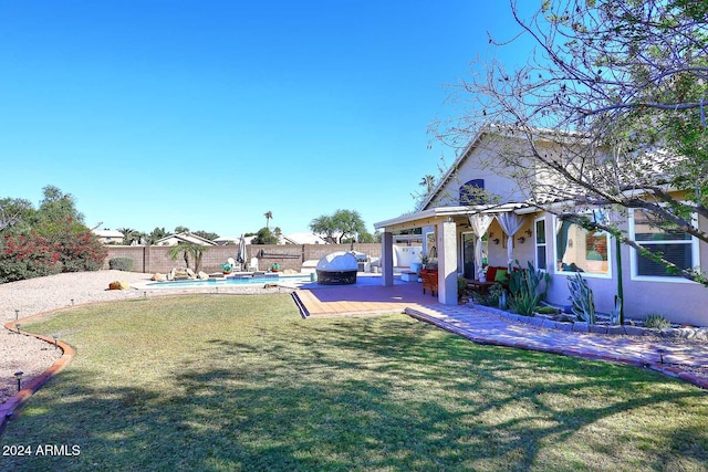 view of yard with a patio and a fenced in pool