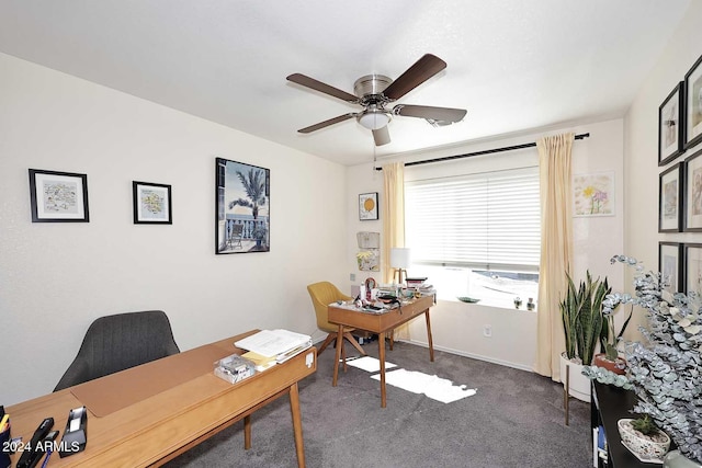 office space with ceiling fan and dark colored carpet