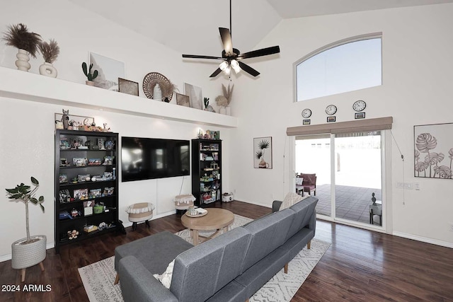 living room with dark wood-type flooring, ceiling fan, and high vaulted ceiling