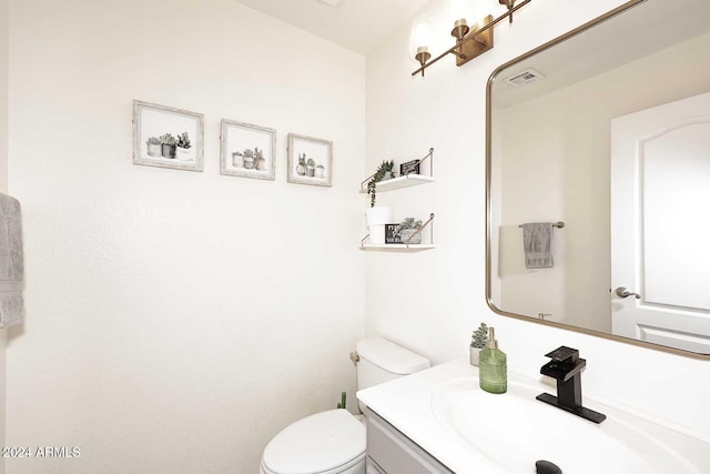 bathroom featuring toilet and vanity