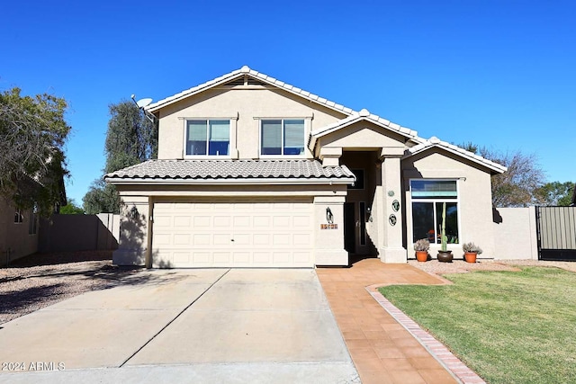 view of front of house with a front lawn and a garage