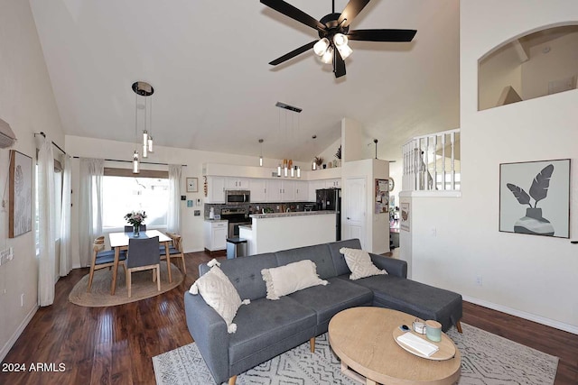 living room featuring ceiling fan, lofted ceiling, and wood-type flooring