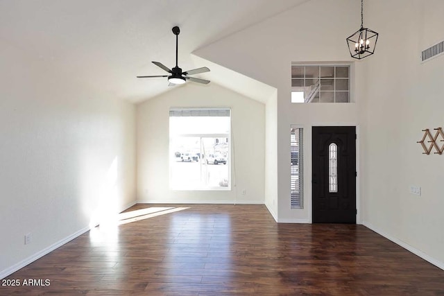 foyer entrance with ceiling fan with notable chandelier and dark wood-type flooring