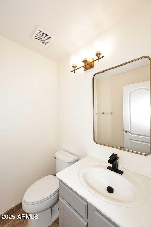 bathroom with toilet and vanity