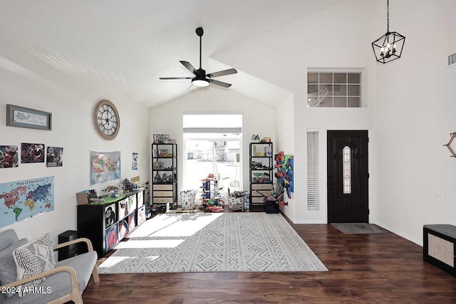 entryway featuring vaulted ceiling, dark hardwood / wood-style floors, and ceiling fan with notable chandelier