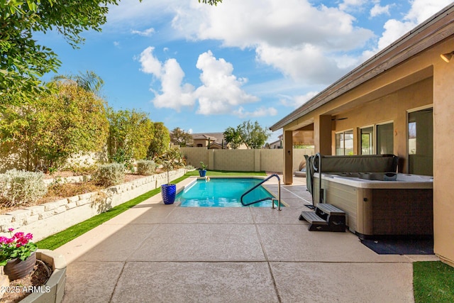 view of pool with a hot tub and a patio area