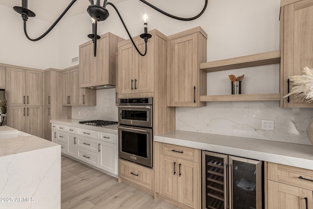 kitchen featuring light hardwood / wood-style floors, stainless steel appliances, decorative backsplash, beverage cooler, and light stone countertops