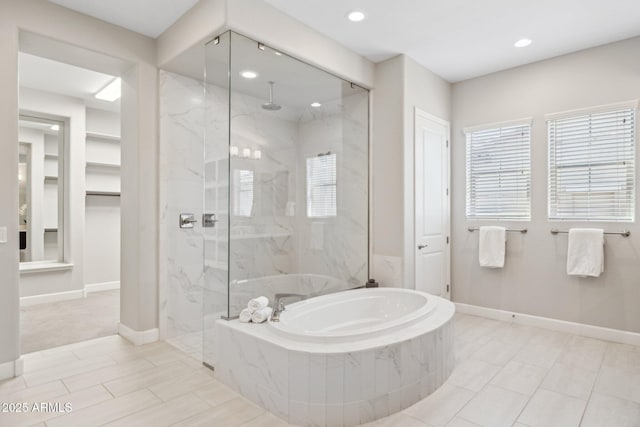 full bath featuring recessed lighting, a marble finish shower, baseboards, and a bath