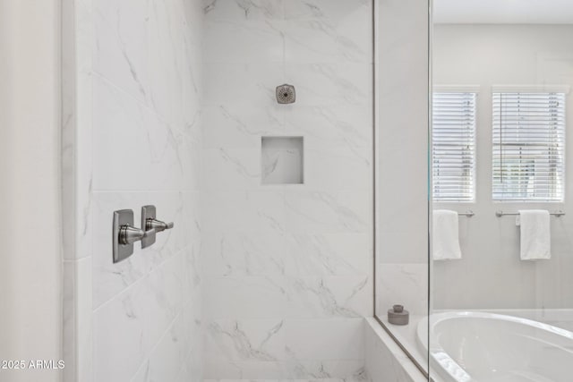 full bathroom featuring a marble finish shower and a washtub