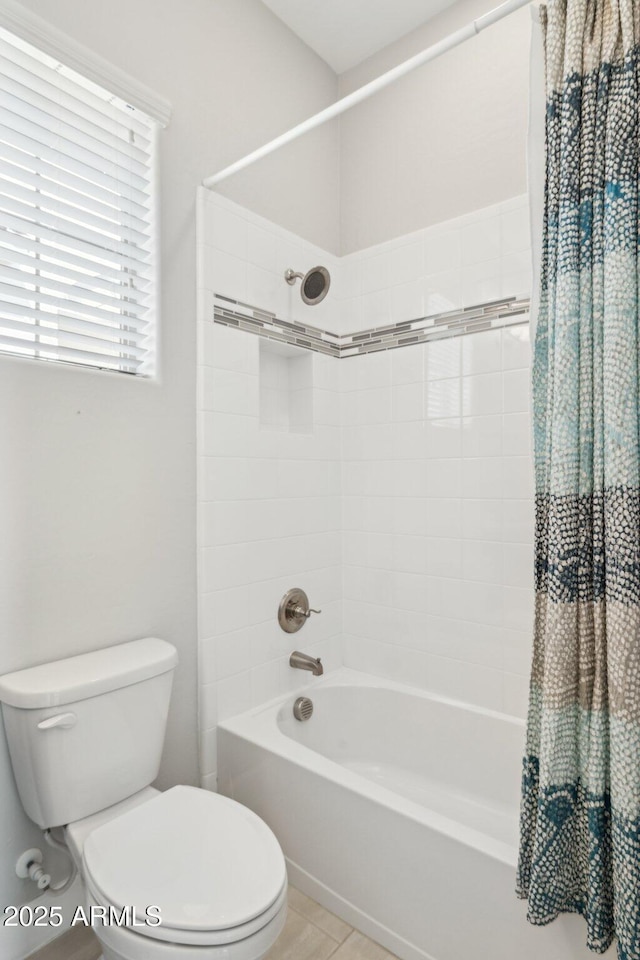 bathroom featuring tile patterned floors, shower / bathtub combination with curtain, and toilet