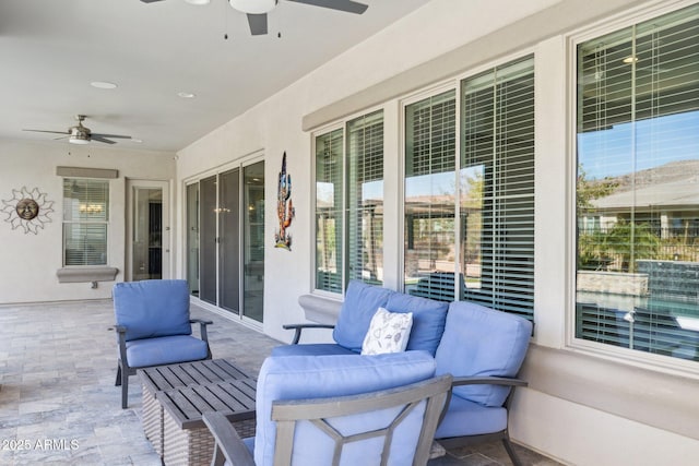 view of patio with an outdoor living space and a ceiling fan