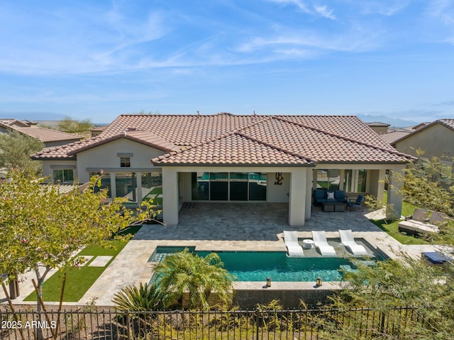 rear view of house featuring a patio area, stucco siding, a tiled roof, and outdoor lounge area