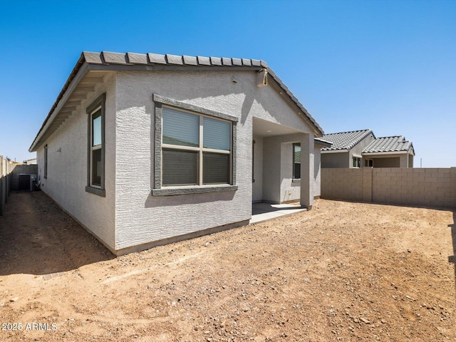 16015 W Desert Hollow Dr, Surprise, AZ 85387 - back of property with a fenced backyard, stucco siding, and central air condition unit
