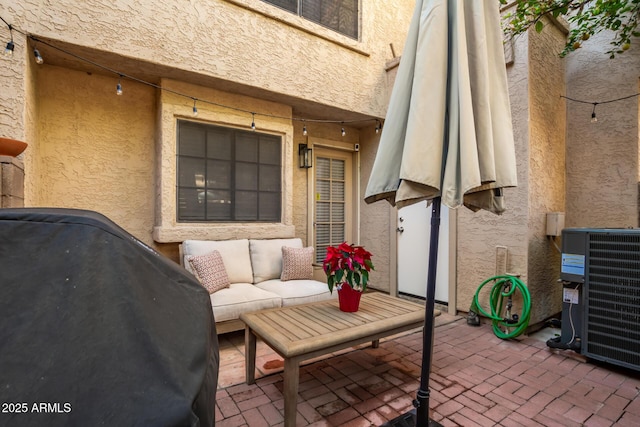 view of patio / terrace featuring outdoor lounge area, a grill, and central air condition unit