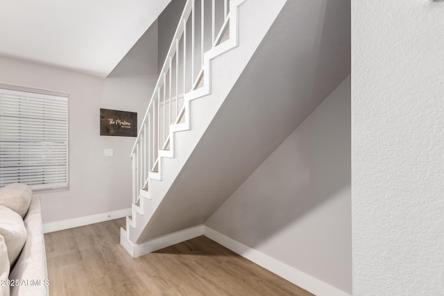 stairway featuring wood-type flooring