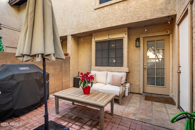 view of patio with a grill and an outdoor living space