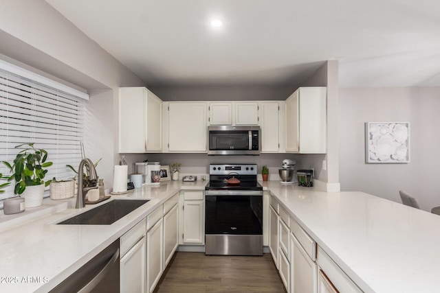 kitchen featuring sink, white cabinets, dark hardwood / wood-style floors, and appliances with stainless steel finishes