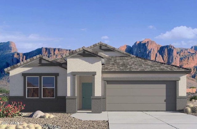 view of front of house featuring a mountain view and a garage