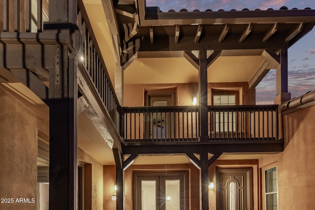 exterior space featuring a balcony and stucco siding