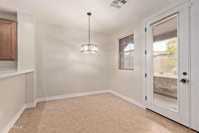 unfurnished dining area featuring visible vents and baseboards