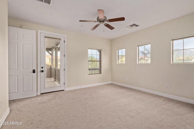 unfurnished room featuring light carpet, visible vents, and baseboards