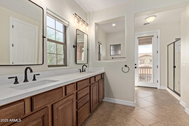 full bathroom featuring a stall shower, tile patterned flooring, visible vents, and a sink