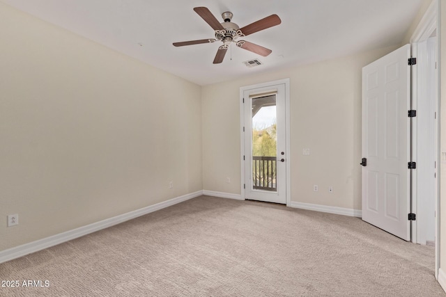 empty room with baseboards, visible vents, a ceiling fan, and light colored carpet