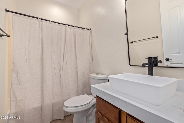 bathroom featuring shower / bath combo with shower curtain, vanity, toilet, and tile patterned floors