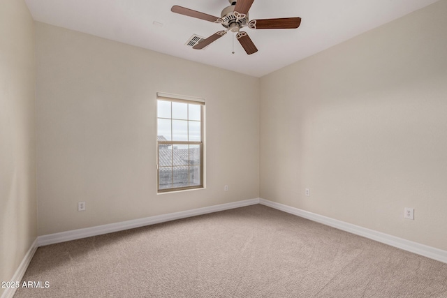 unfurnished room with carpet, visible vents, ceiling fan, and baseboards