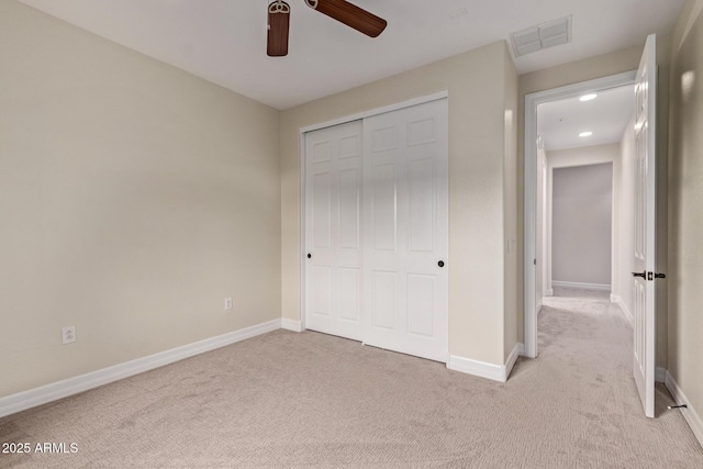 unfurnished bedroom with ceiling fan, carpet floors, visible vents, baseboards, and a closet