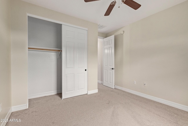 unfurnished bedroom with ceiling fan, a closet, carpet flooring, and baseboards