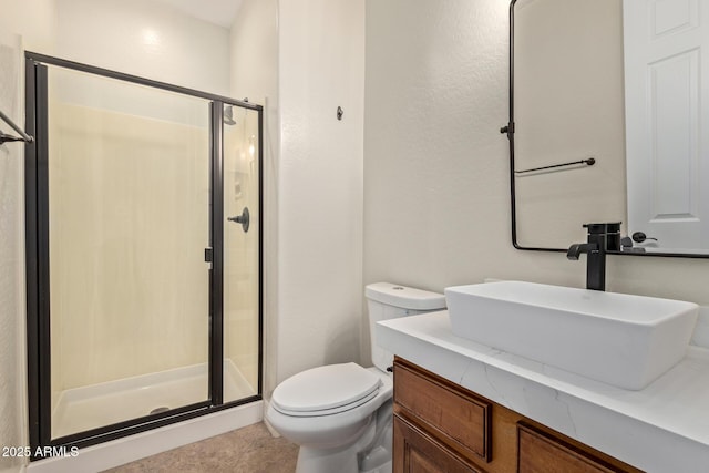 full bath featuring vanity, a shower stall, and toilet