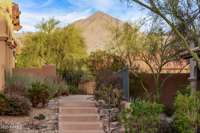 view of yard featuring fence and a mountain view