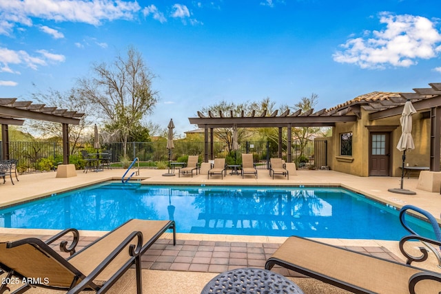 pool with a patio area, fence, and a pergola