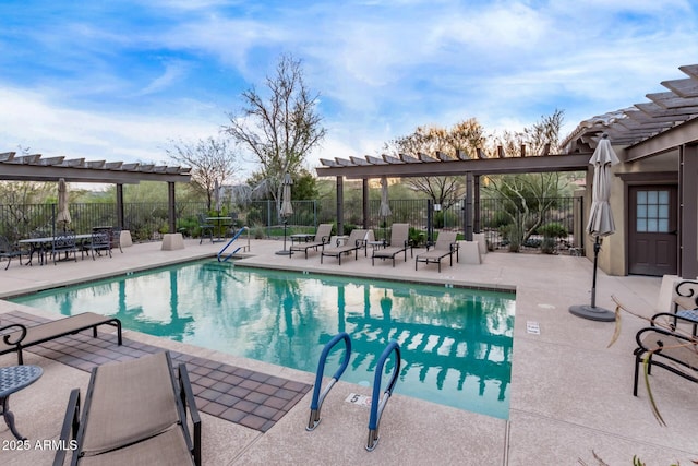 pool with a pergola, fence, and a patio