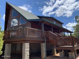 view of property exterior featuring an attached garage and stairway
